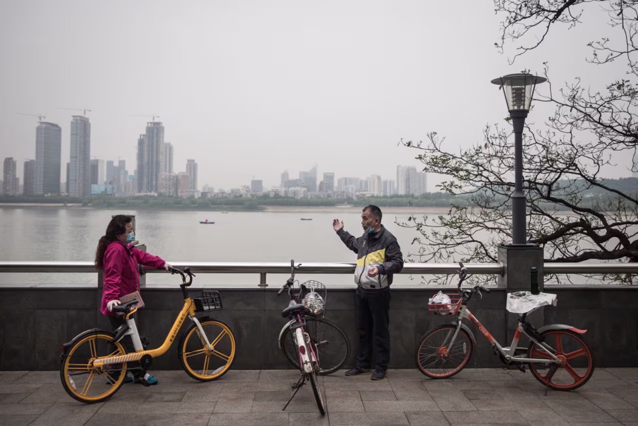 Two people talk near the Yangtze River in Wuhan, China, on April 21.