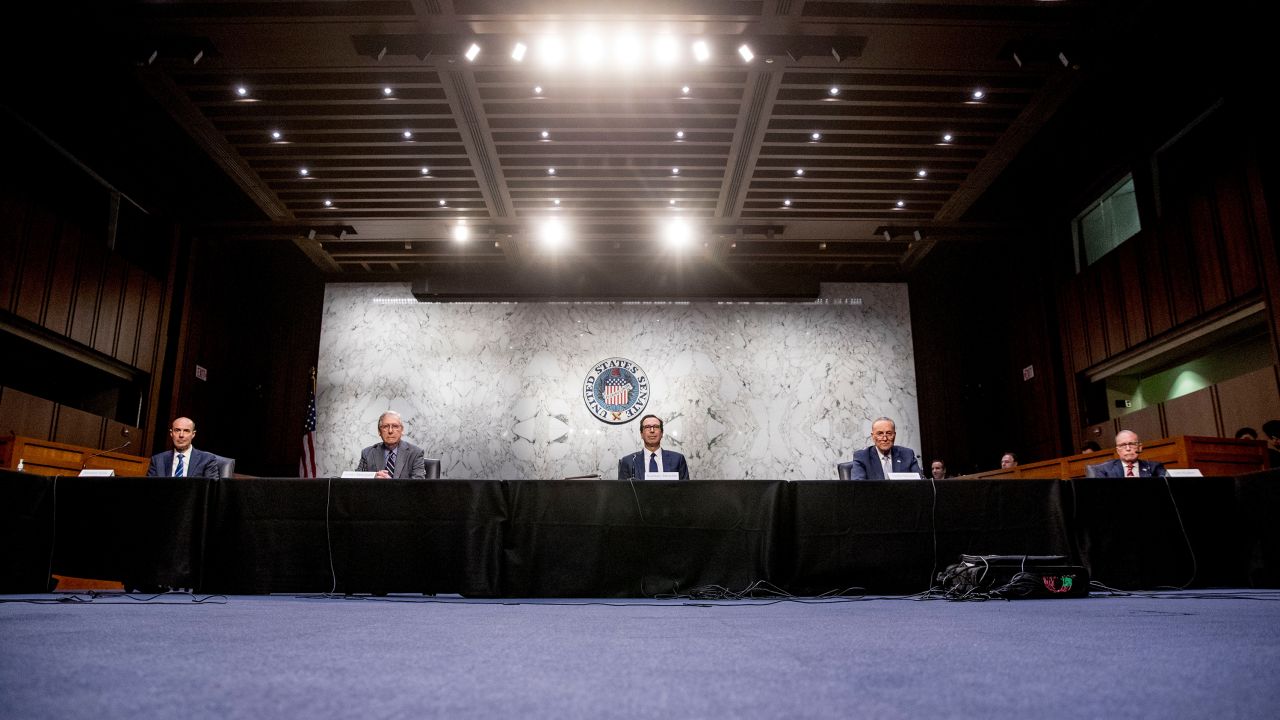 From left, Labor Secretary Eugene Scalia, Senate Majority Leader Mitch McConnell of Ky., Treasury Secretary Steven Mnuchin, Senate Minority Leader Sen. Chuck Schumer of N.Y., and White House chief economic adviser Larry Kudlow attend a a meeting to discuss the coronavirus relief bill on Capitol Hill, Friday, March 20, 2020, in Washington. (AP Photo/Andrew Harnik)
